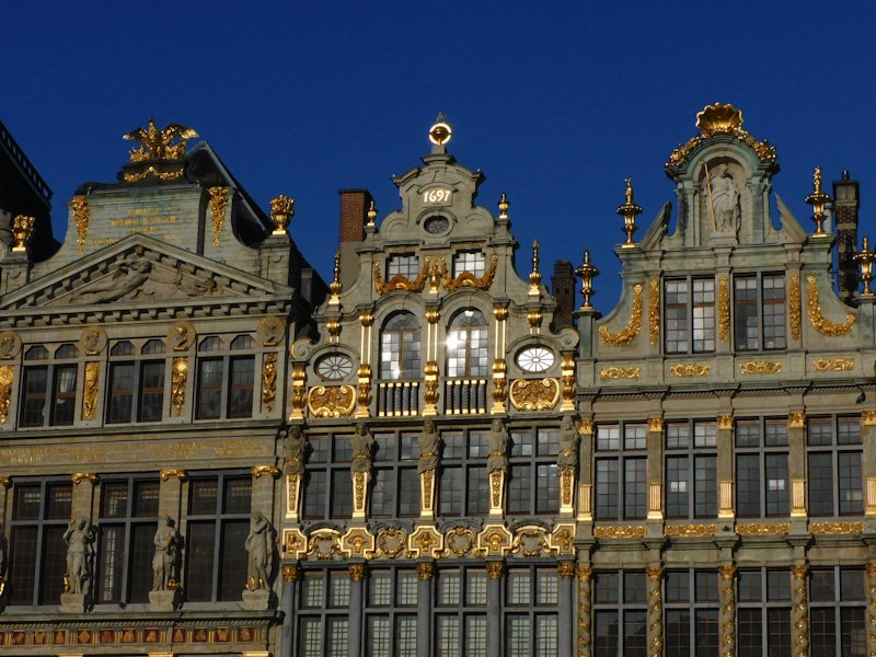 Gilded buildings in Brussels' Grand-Place reflecting sunlight. This is a top attraction during a weekend in Belgium