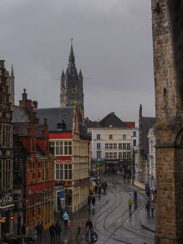 View of a bustling street in Ghent next to the ancient Gravensteen.