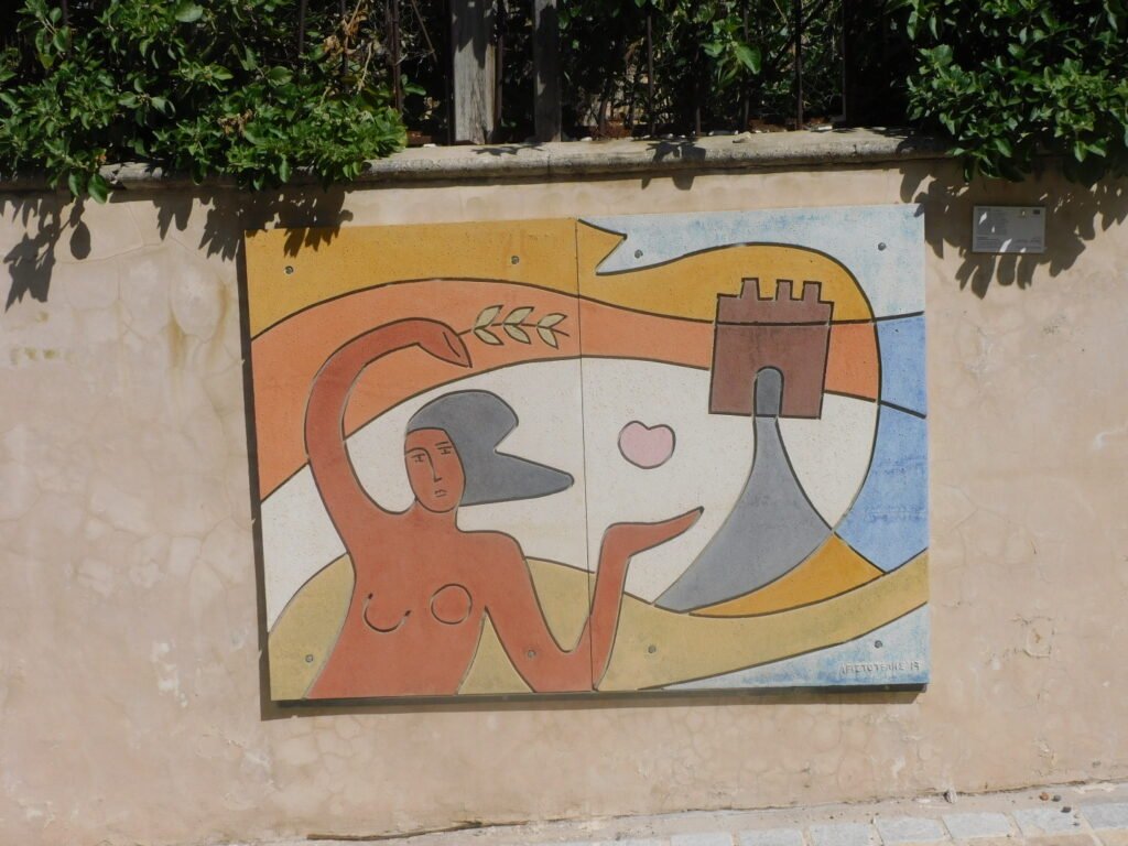 Street art in Paphos, Cyprus - image of a woman dancing with ruins in the background.