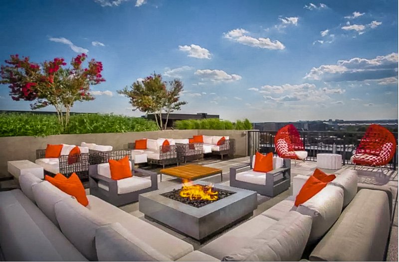 Expansive rooftop deck area with cozy furniture.