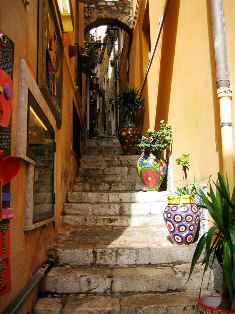 Alleyway in Torremolinos, lined with decorative vases, are among the top things to do in Spain's Costa del Sol.