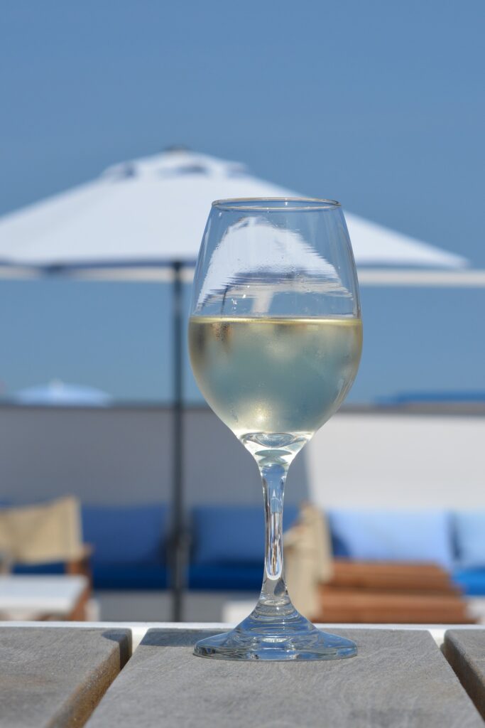 Glass of wine on a table at a beachfront bar