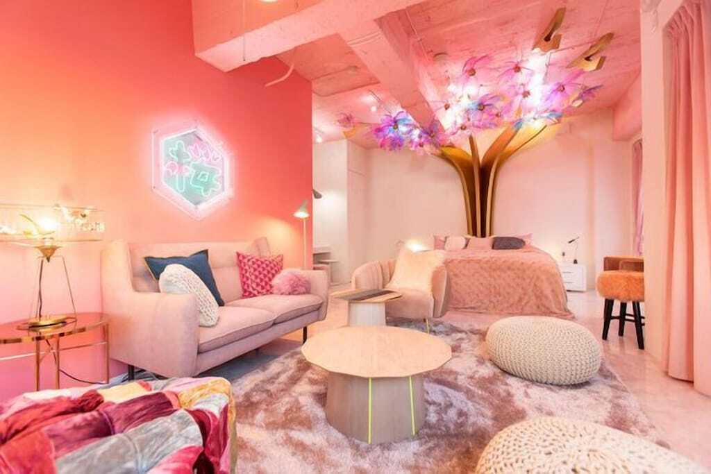 Bedroom and living room of Tokyo Airbnb with bright pink neon kawaii decor