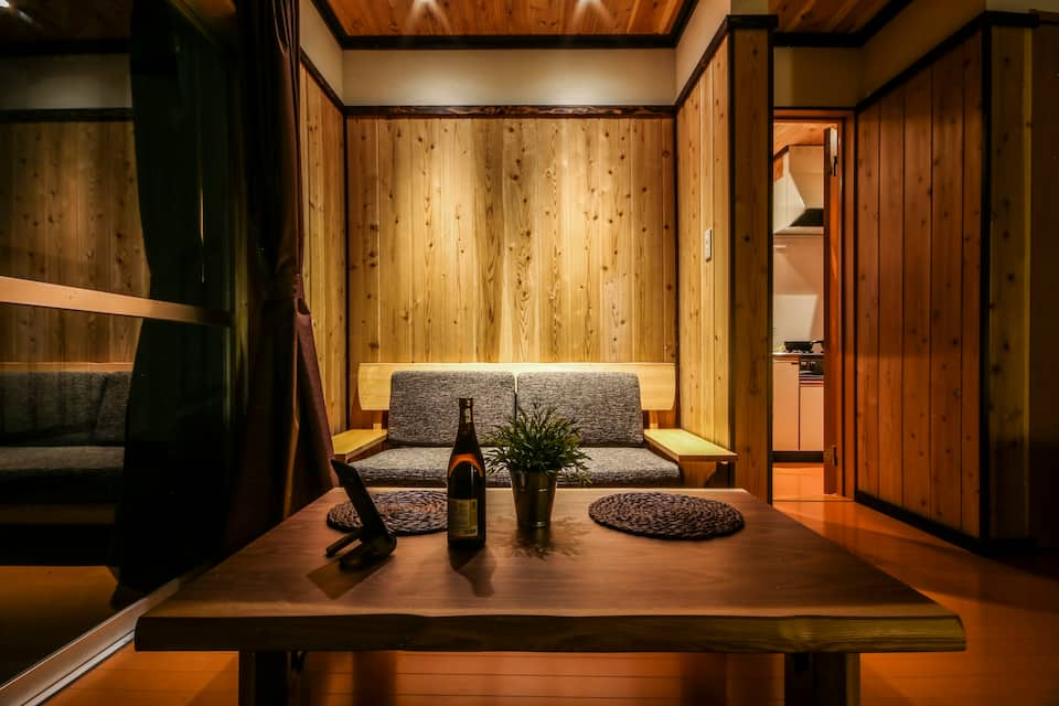 A wood-paneled miniature lounge area with a comfy sofa