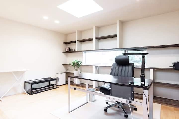 Stark black-and-white office area with work desk and ample shelf space