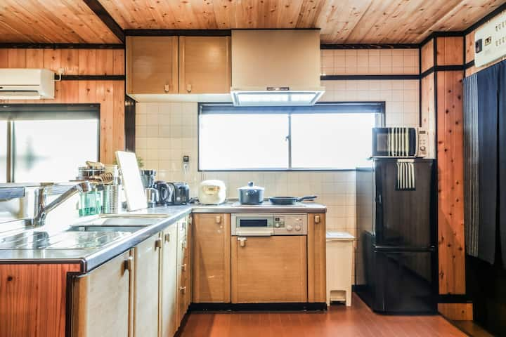 Full kitchen of apartment rental with fridge, oven, sink, and microwave