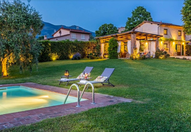 Relax by the poolside at this vacation villa in Italy.