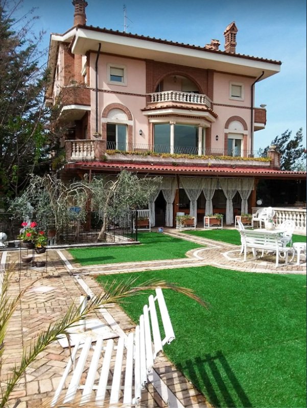 A large villa in Italy to rent with outdoor seating that offers a welcoming space to relax after big-city exploring.