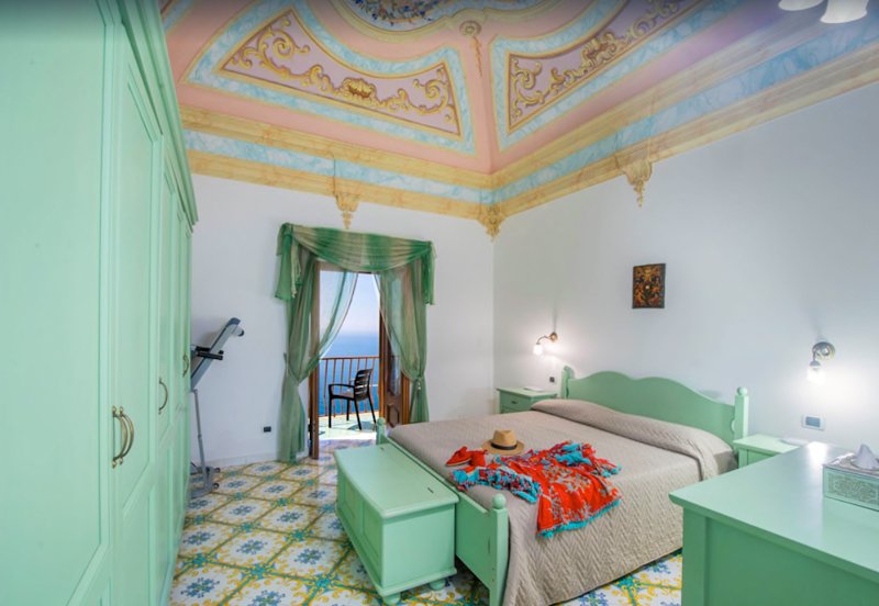 A charming bedroom with so much character at a historic Italian villa for rent. 